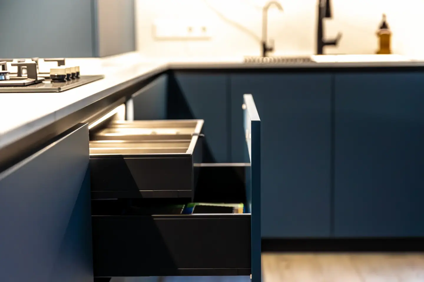 close-up-view-of-the-corner-kitchen-open-drawers-cooking-zone-in-needham-ma
