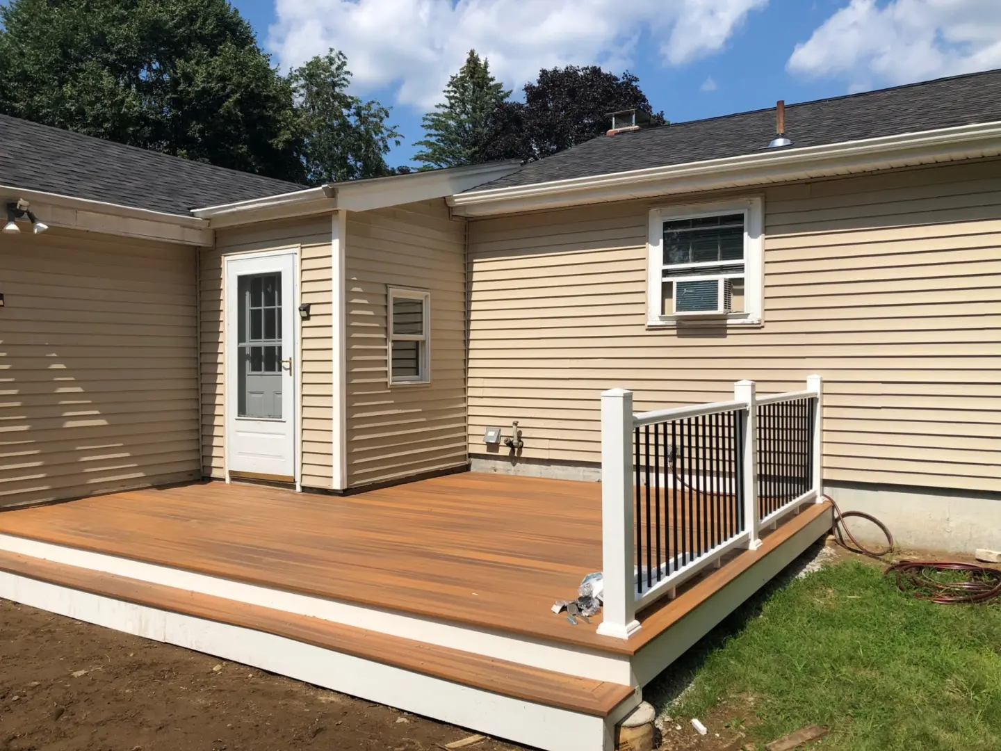 custom-wooden-deck-with-white-and-black-railing-in-needham-ma
