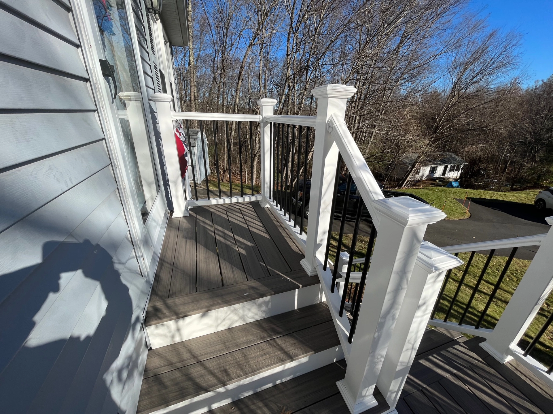 deck-stairs-with-railing-and-big-trees-on-the-background-in-needham-ma