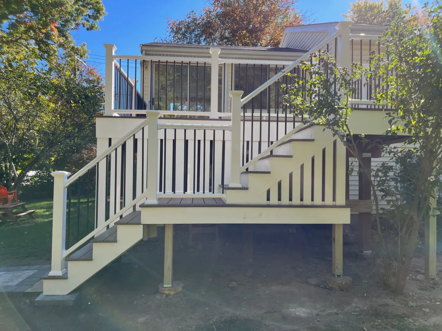 elevated-composite-deck-with-screened-porch-and-trees-on-the-background-in-needham-ma