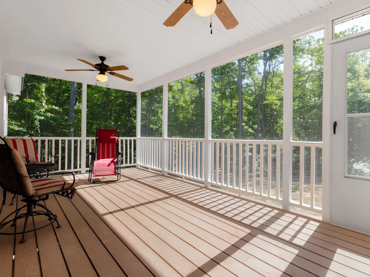 interior-of-the-screened-in-porch-with-chairs-and-surrounded-by-big-trees-in-needham-ma