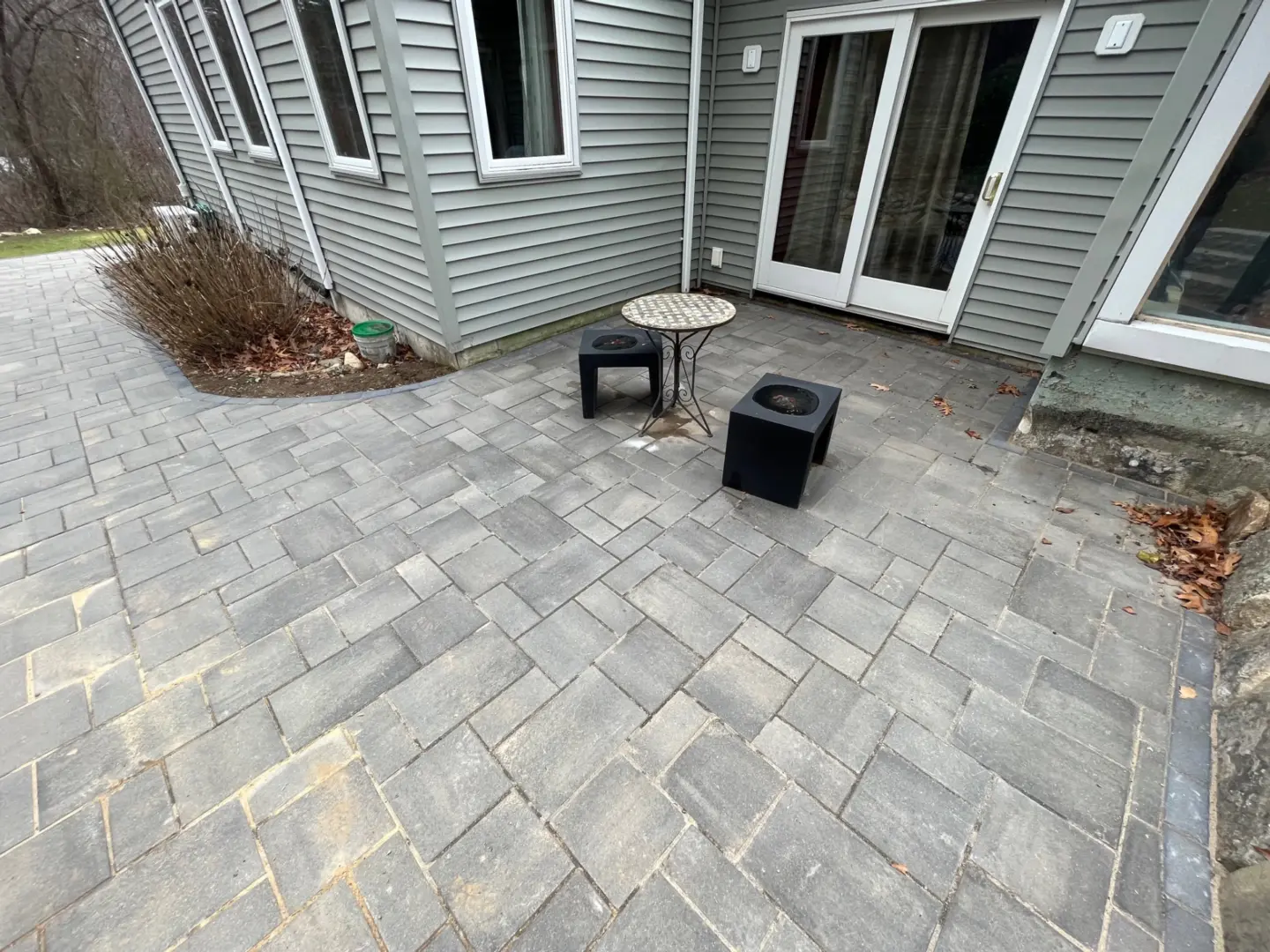patio-with-chairs-and-table-in-front-of-sliding-glass-window-door-in-needham-ma