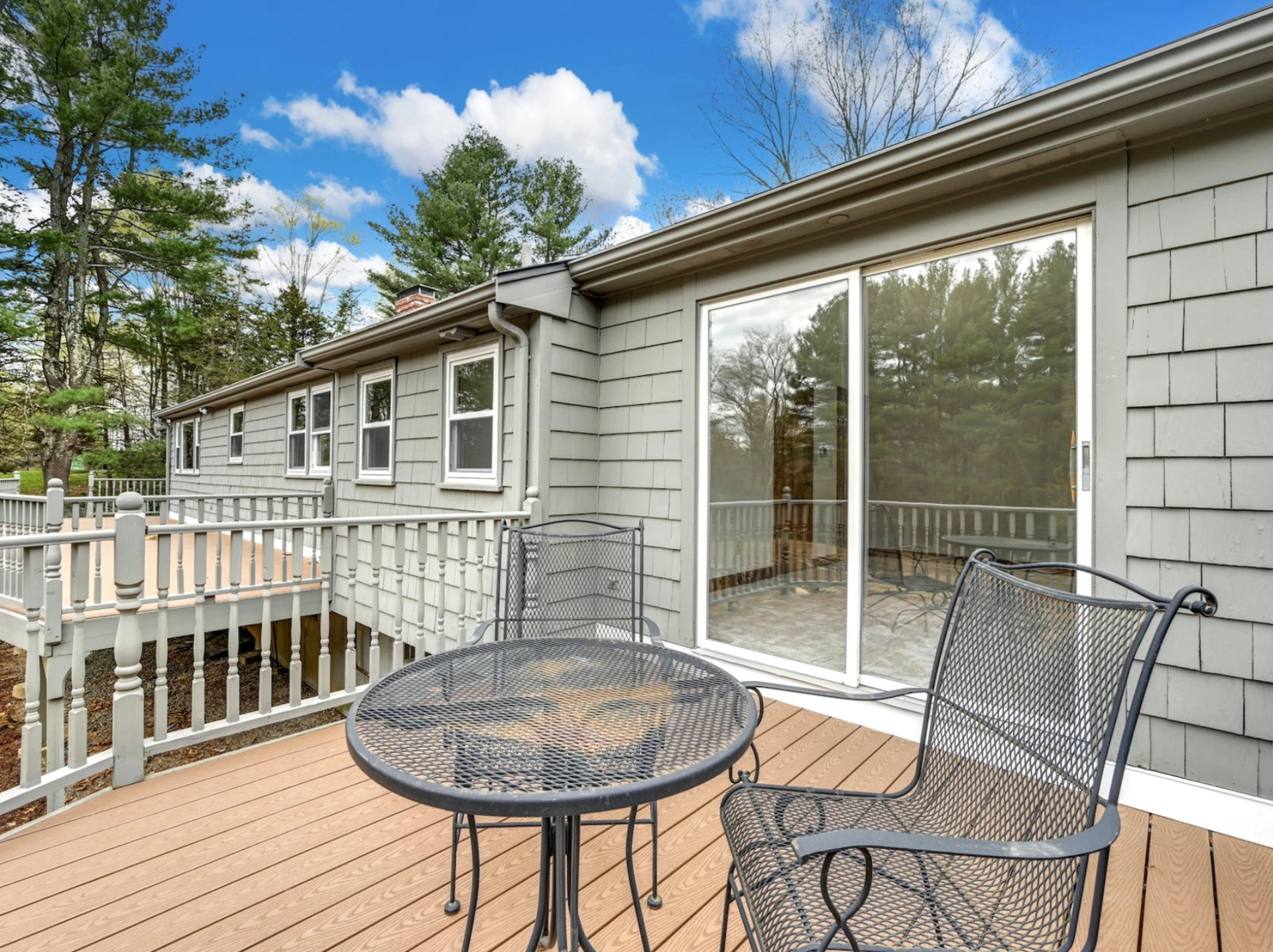 residential-deck-with-outdoor-furniture-and-glass-window-door-in-needham-ma