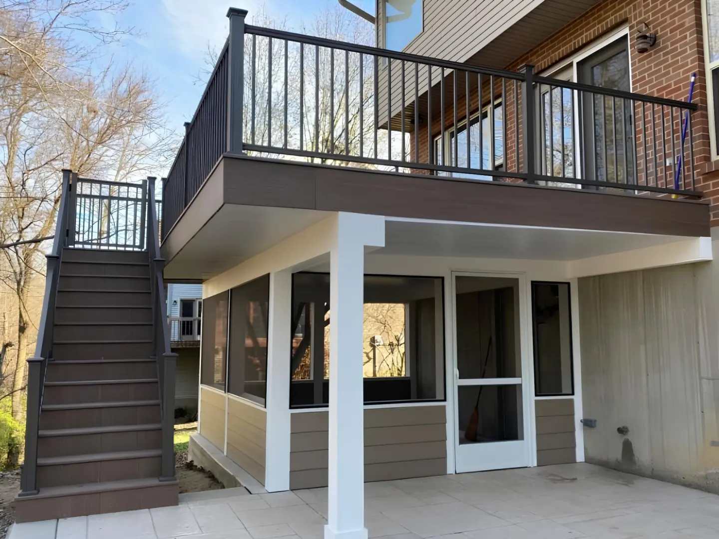 screen-porch-on-the-commercial-under-deck-with-black-metal-railing-and-gate-in-needham-ma