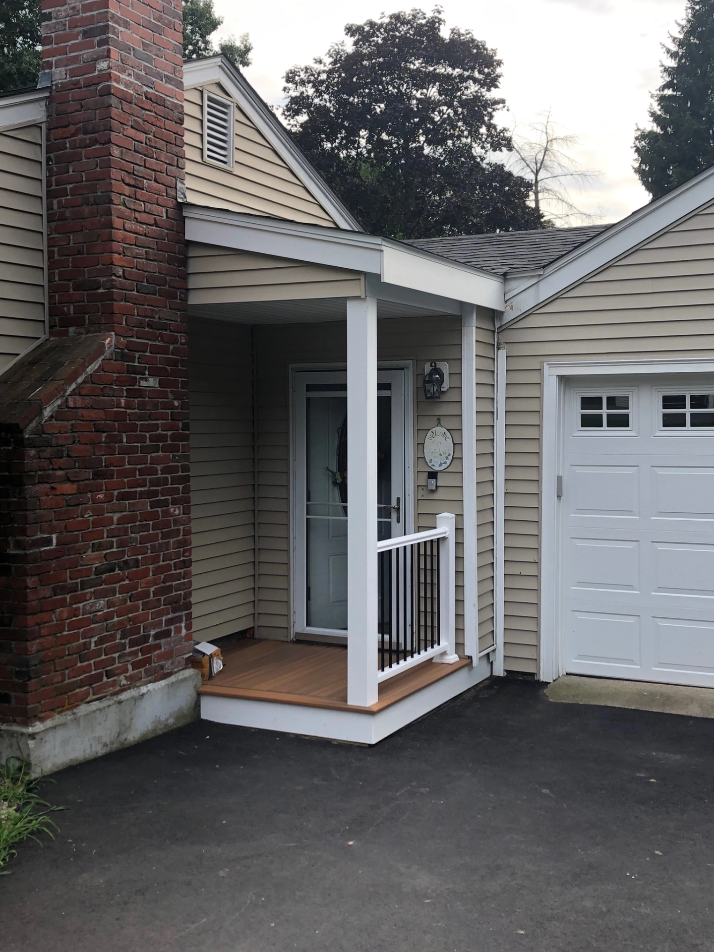 small-deck-with-small-railing-on-the-front-door-in-needham-ma